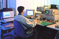 SOYO engineer performing signal integrity measurements on a green PCB
